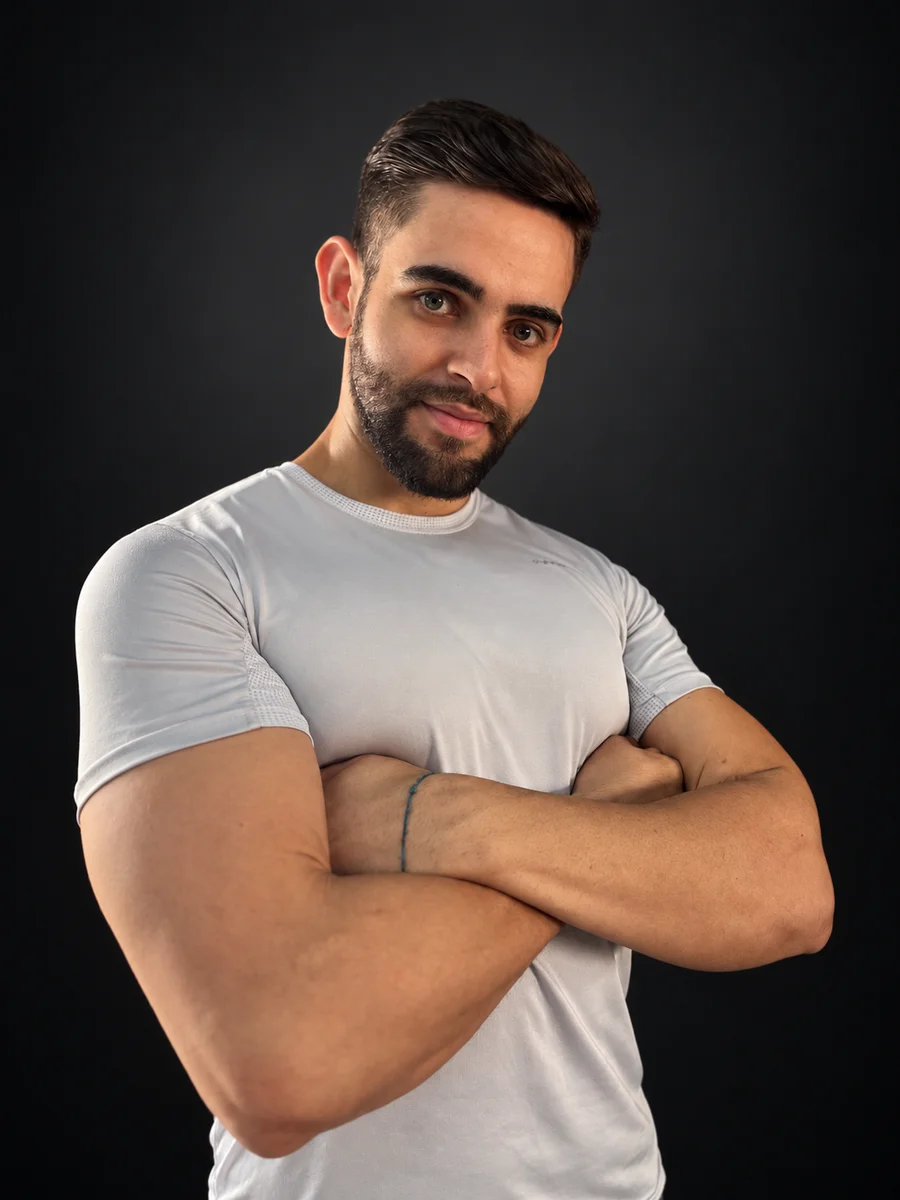 João Cleber sorrindo de braços cruzados